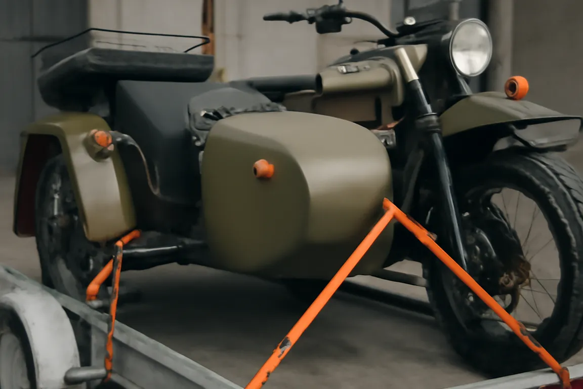 An Ural sidecar being loaded onto an enclosed transport trailer